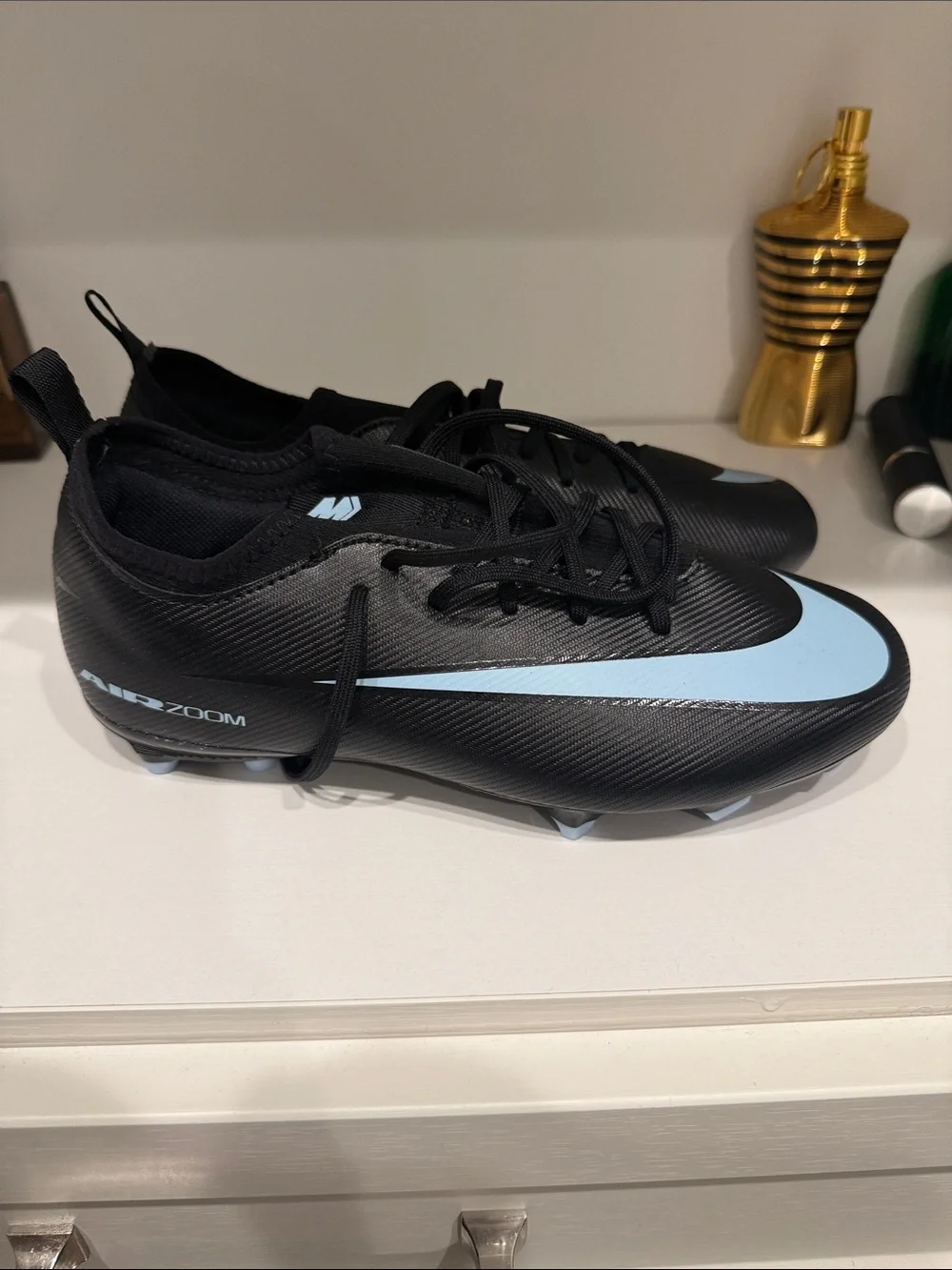 Nike Men’s Black Athletic Cleats with Light Blue Swoosh